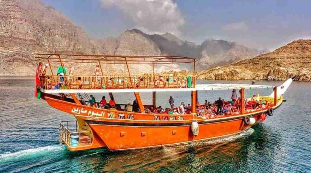 Traditional Omani dhow cruising through the majestic Musandam Dibba fjords.