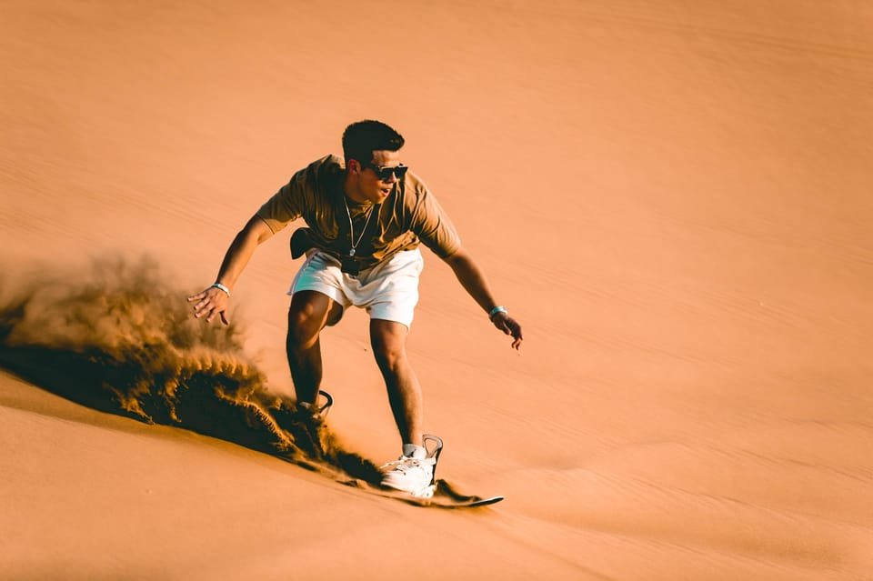 Sandboarding activity on desert dunes